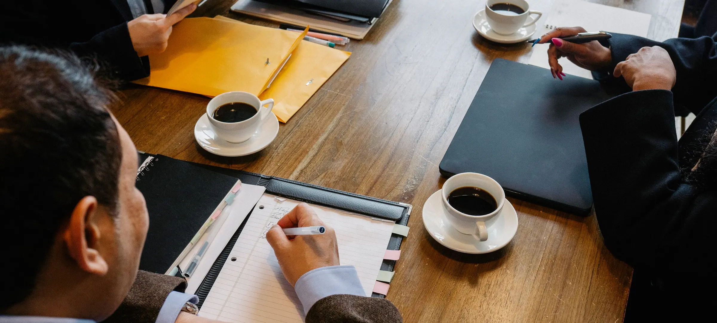 A working session around a table with documents and notebooks